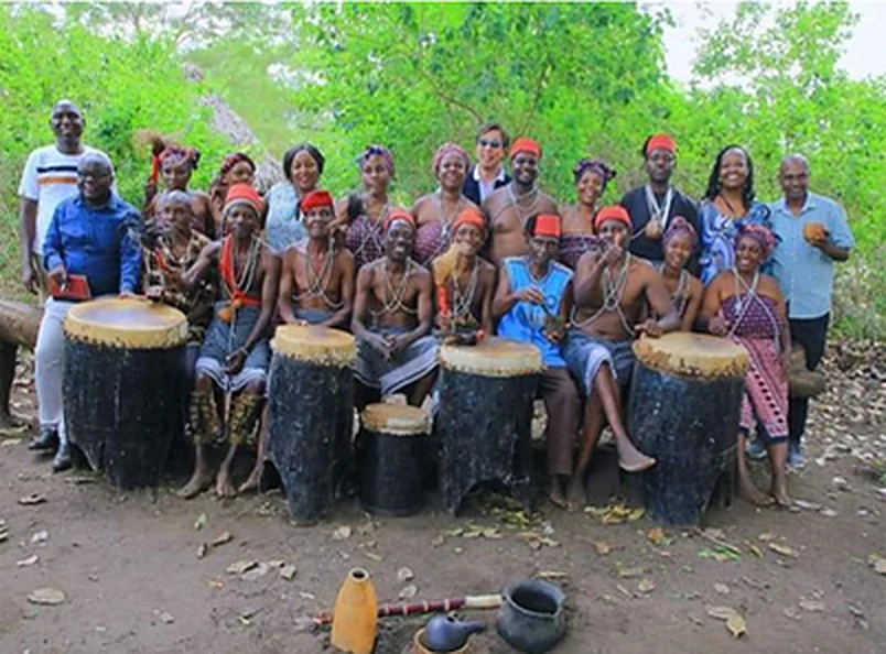 The Mwazindika dance group and their drums gathered with festival guests in a forest clearing.